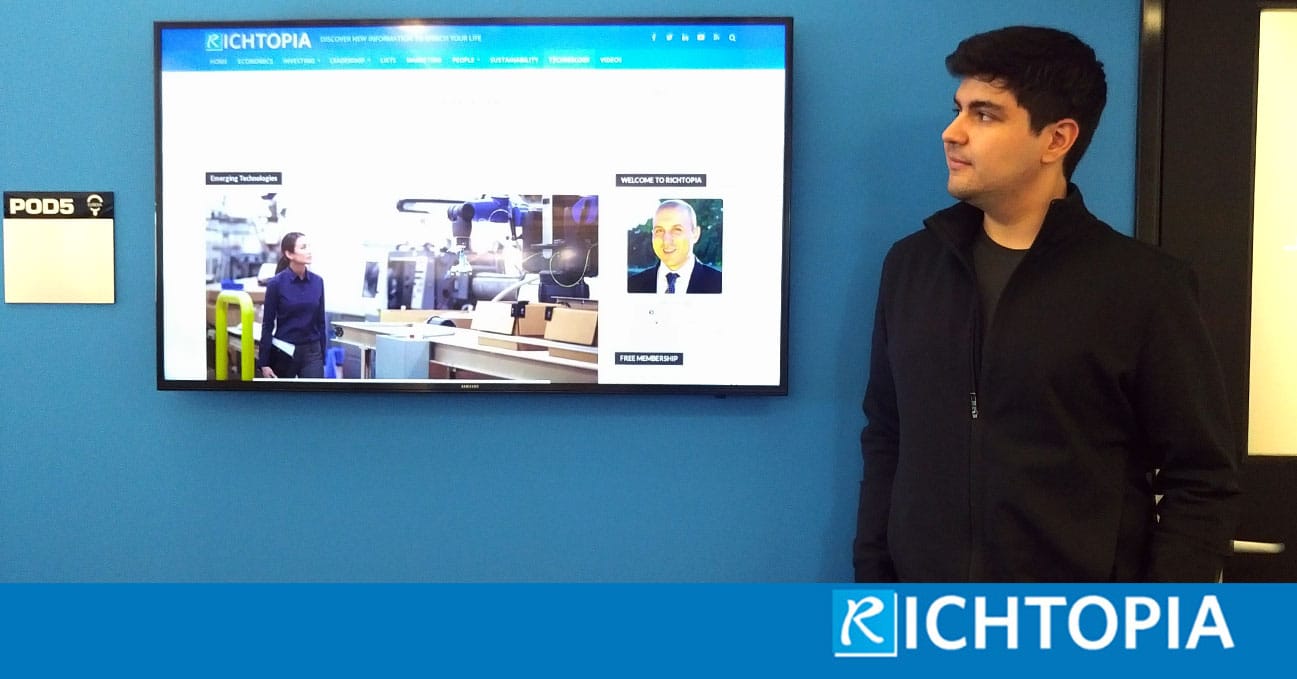 Photo of Peter Polydor reading Richtopia.com on a TV screen at work